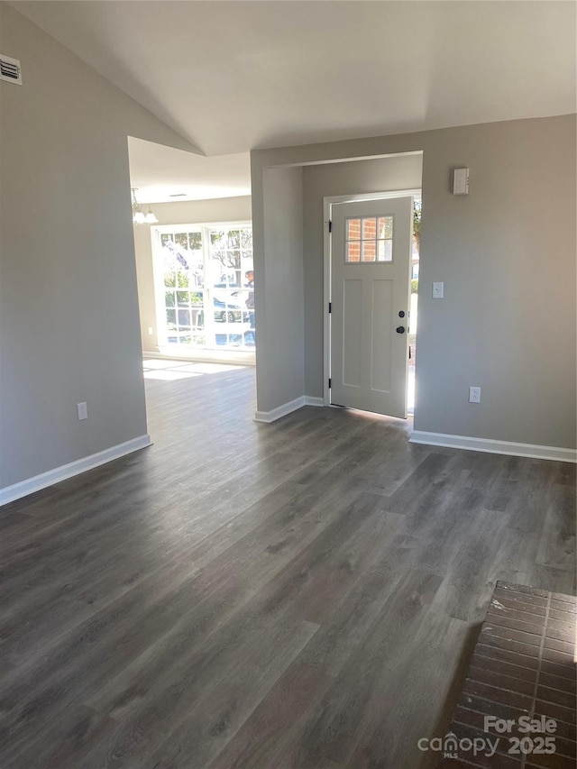 entryway with vaulted ceiling, baseboards, dark wood-style flooring, and visible vents