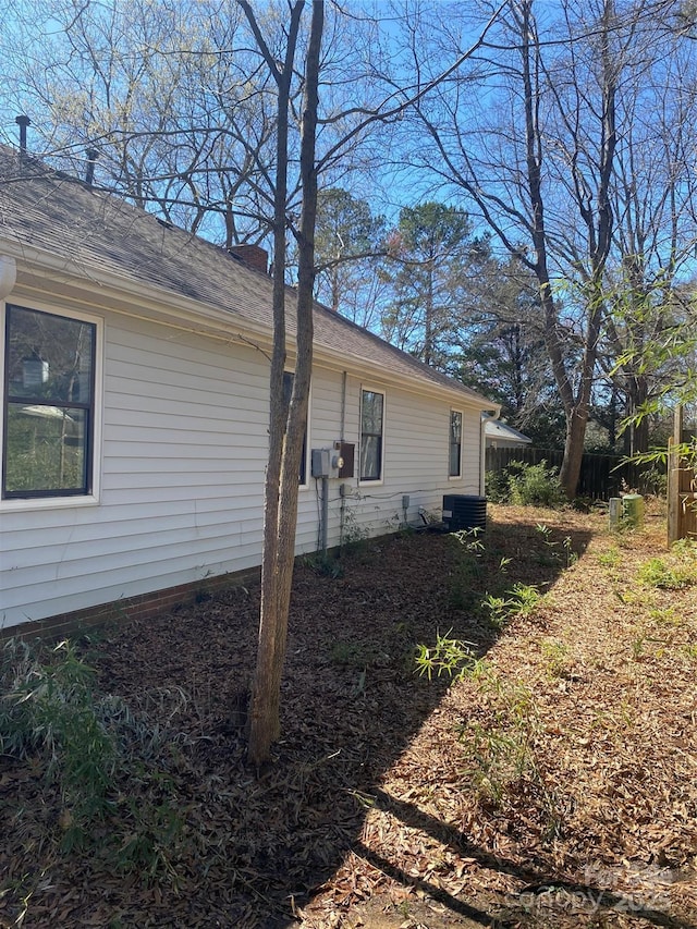 view of side of home with central air condition unit