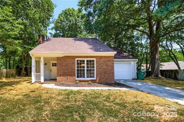 ranch-style house with fence, a front yard, an attached garage, brick siding, and a chimney