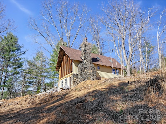 view of side of home featuring a shingled roof