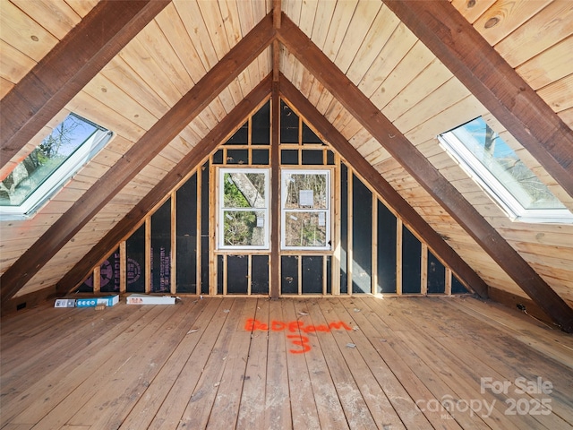 unfinished attic featuring a skylight