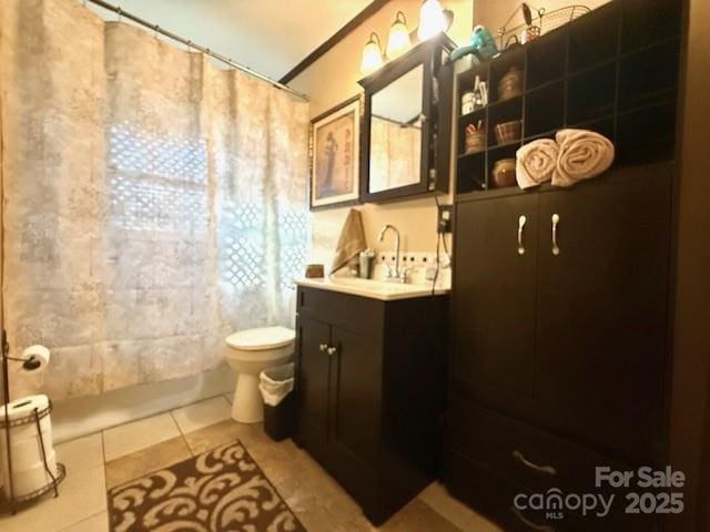 full bathroom featuring a shower with curtain, tile patterned floors, toilet, and vanity