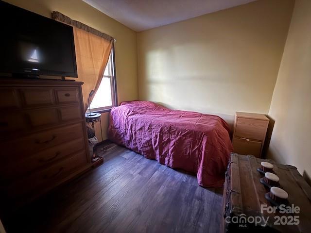 bedroom with dark wood-style floors