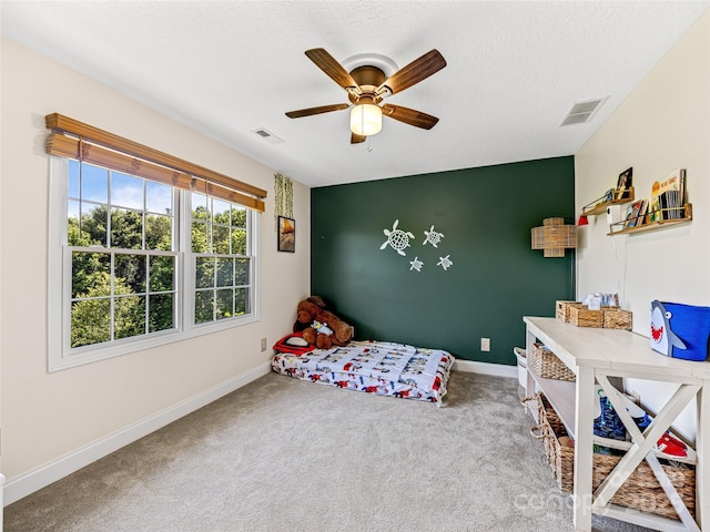 bedroom with visible vents, carpet, baseboards, and an accent wall