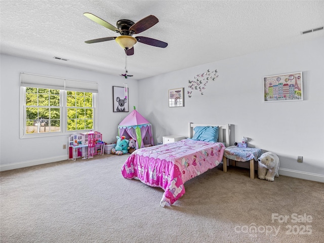 bedroom with a textured ceiling, carpet, visible vents, and baseboards