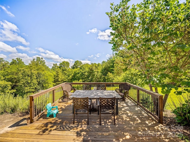 wooden deck featuring outdoor dining space