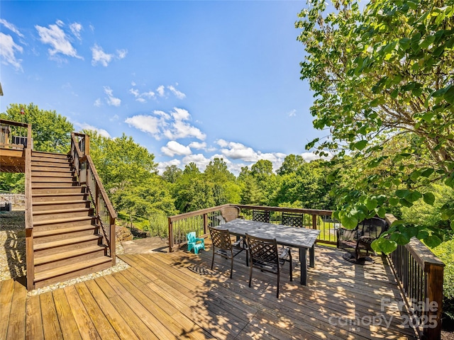 wooden deck with stairway and outdoor dining space