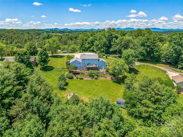 drone / aerial view with a view of trees and a mountain view