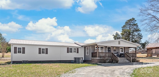 manufactured / mobile home with central air condition unit, a porch, metal roof, and a front yard