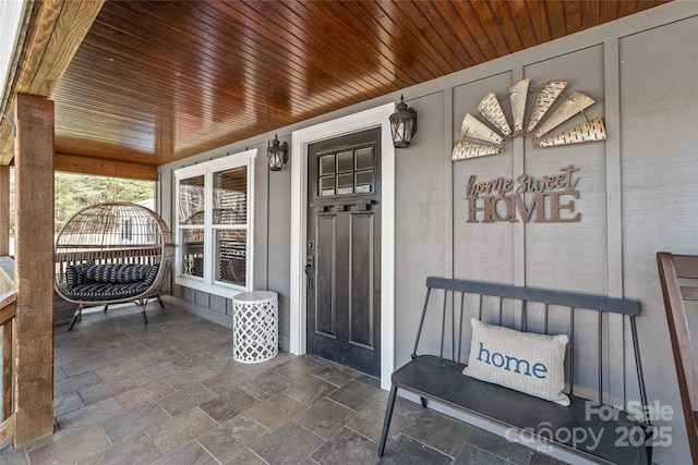 view of exterior entry with a porch