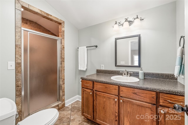 bathroom with toilet, lofted ceiling, a stall shower, tile patterned floors, and vanity