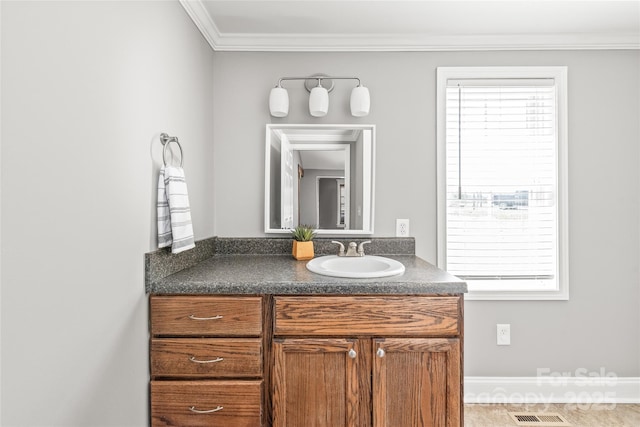 bathroom with vanity, crown molding, and visible vents