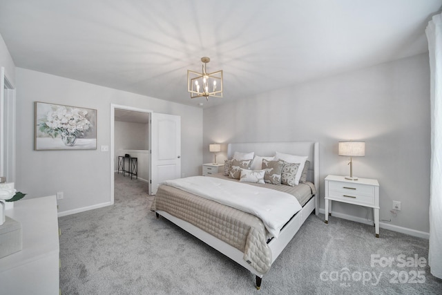 carpeted bedroom with baseboards and a chandelier