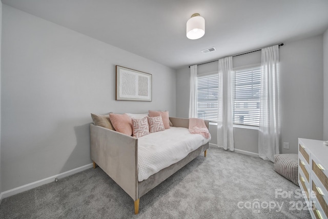 carpeted bedroom with visible vents and baseboards