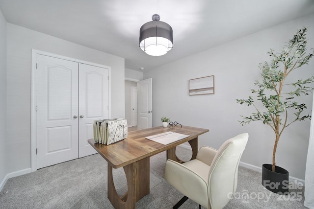 home office with baseboards and light colored carpet