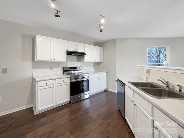 kitchen featuring dark wood-style flooring, a sink, white cabinets, under cabinet range hood, and appliances with stainless steel finishes