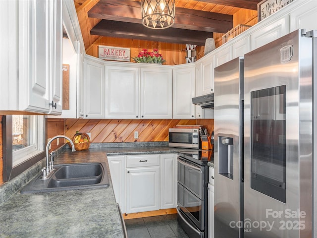 kitchen featuring a sink, appliances with stainless steel finishes, under cabinet range hood, beam ceiling, and white cabinetry