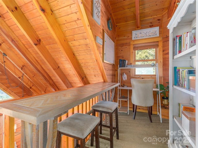 interior space with wood ceiling, wooden walls, and vaulted ceiling with beams