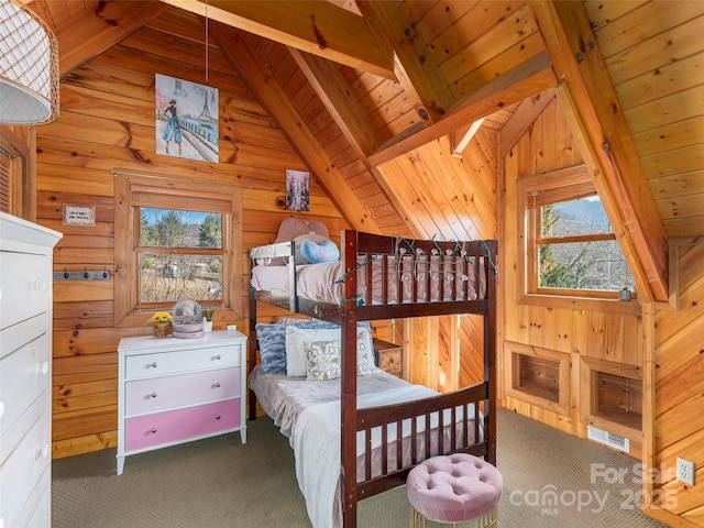 carpeted bedroom featuring visible vents, wood walls, multiple windows, and lofted ceiling with beams