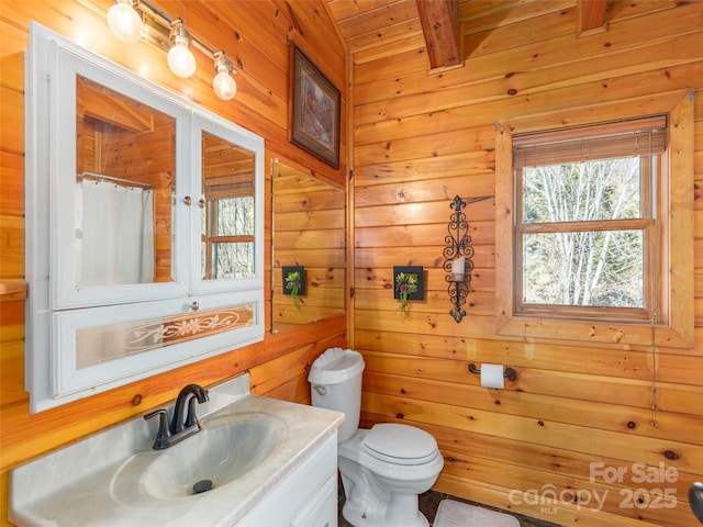 bathroom with vanity, wooden walls, toilet, beamed ceiling, and wood ceiling