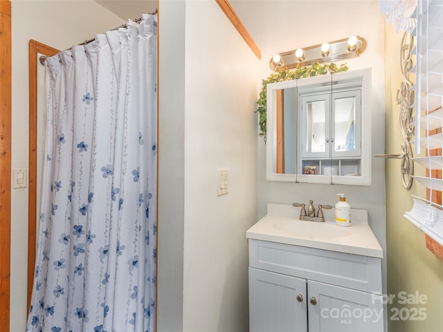 full bathroom with vanity and a shower with curtain