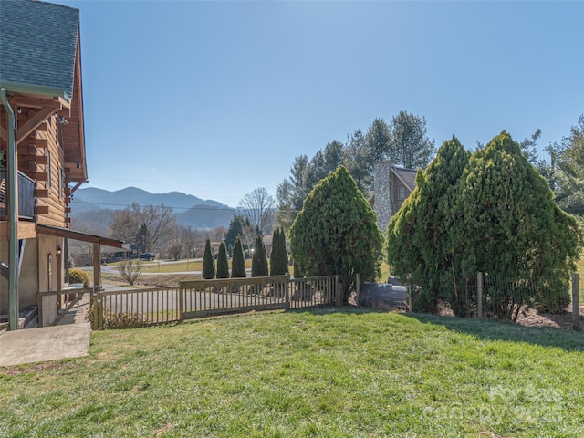 view of yard with a mountain view and fence