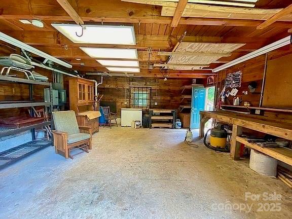 interior space featuring wooden walls and a workshop area