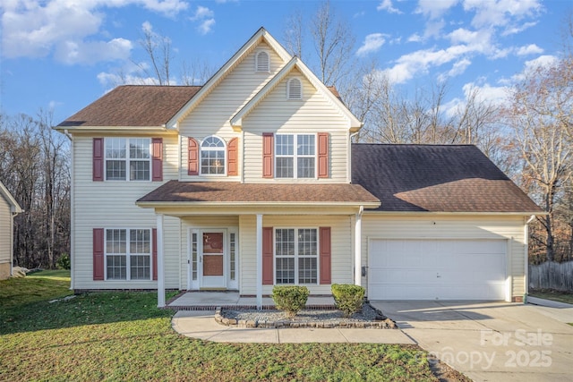 traditional home with a front lawn, a garage, driveway, and a shingled roof