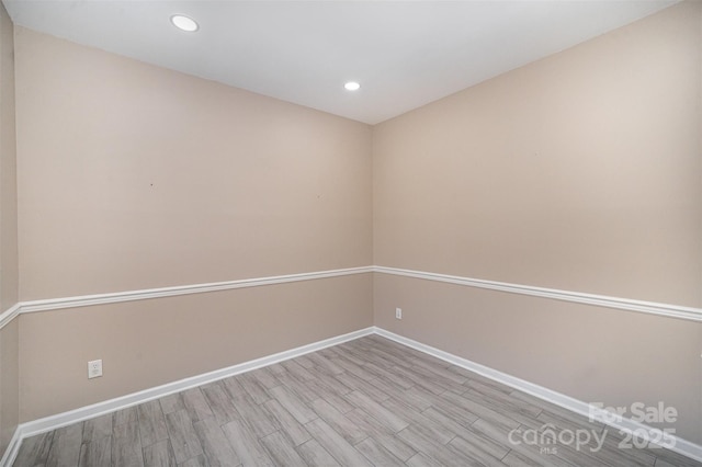 spare room with recessed lighting, wood finished floors, and baseboards