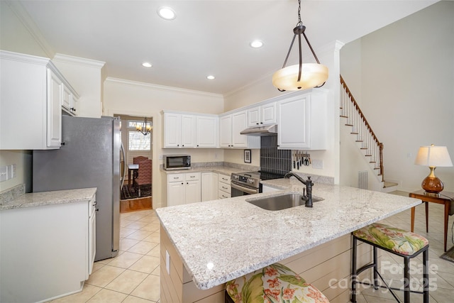 kitchen featuring a peninsula, light tile patterned flooring, a kitchen breakfast bar, under cabinet range hood, and stainless steel appliances