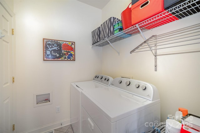 laundry room with separate washer and dryer, baseboards, and laundry area