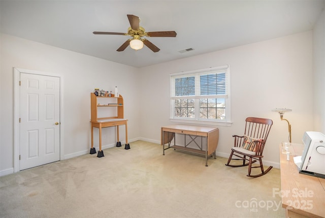 sitting room with ceiling fan, visible vents, baseboards, and carpet