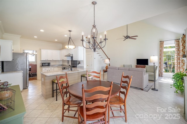 dining room featuring crown molding, lofted ceiling, recessed lighting, ceiling fan with notable chandelier, and light tile patterned floors