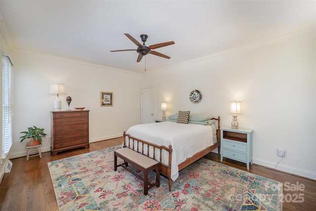 bedroom with baseboards, ornamental molding, and wood finished floors