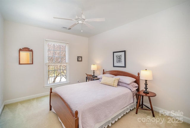 bedroom featuring visible vents, baseboards, ceiling fan, and light carpet