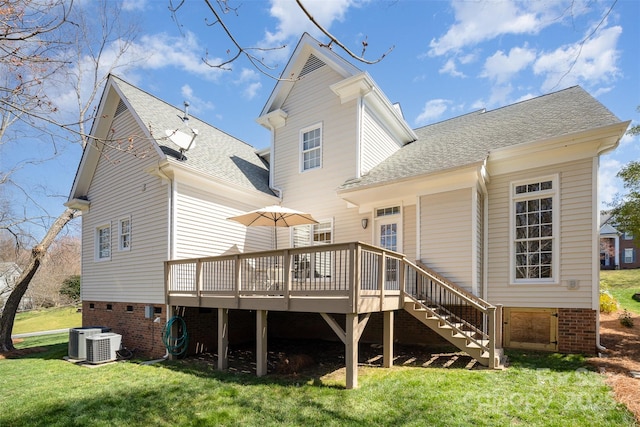 rear view of property with a lawn, stairway, a wooden deck, and a shingled roof