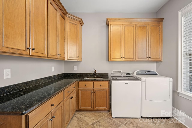 laundry area with a sink, cabinet space, and washer and dryer