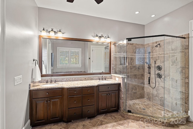 bathroom featuring a sink, a stall shower, and double vanity