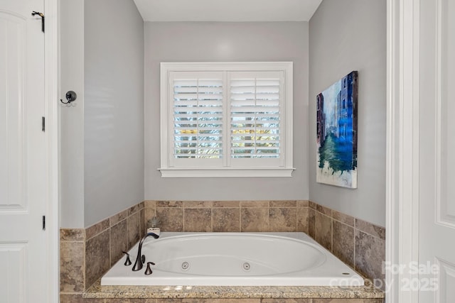 bathroom featuring a tub with jets