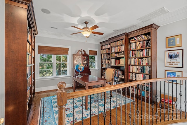 office featuring visible vents, wood finished floors, and crown molding