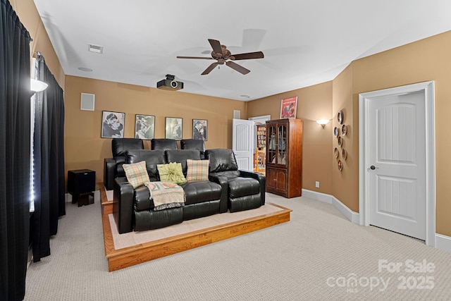 interior space with visible vents, baseboards, light carpet, and ceiling fan