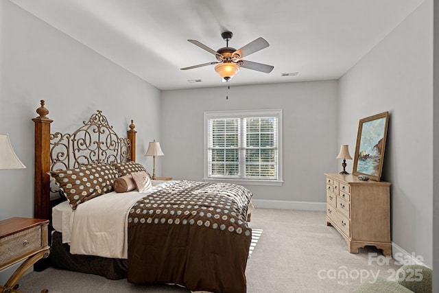 bedroom with a ceiling fan, visible vents, baseboards, and light carpet