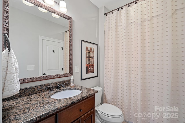 full bath with vanity, a shower with shower curtain, and toilet