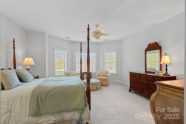 bedroom featuring light carpet, visible vents, baseboards, and ceiling fan