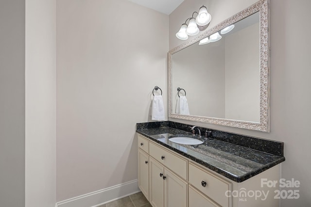 bathroom with tile patterned flooring, vanity, and baseboards