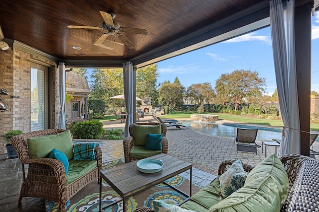 view of patio featuring a ceiling fan, outdoor lounge area, and a pool with connected hot tub