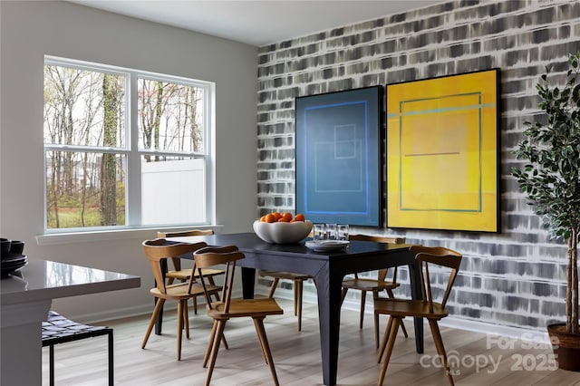 interior space with baseboards and light wood finished floors