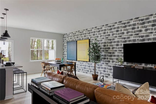 living area with baseboards and light wood finished floors