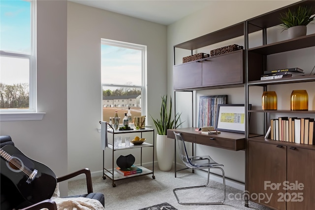 carpeted office space with baseboards