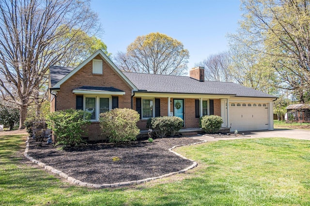 view of front of property with brick siding, a front lawn, a chimney, a garage, and driveway